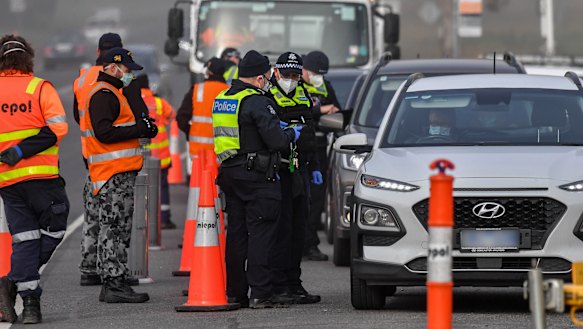 Victorian Police and the ADF Australian defence force man a road block at Coldstream.