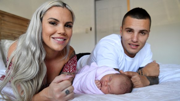 Sammy Stokes, her partner Andy and their baby girl Sunny at their home in Kallangur. The couple made the decision to have a homebirth due to COVID-19 social distancing rules at hospital. 