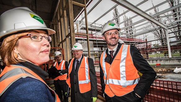 ACT Minister for Higher Education Meegan Fitzharris, vice-chancellor Brian Schmidt (second from left), and Chief Minister Andrew Barr took a tour of the work in progress on Tuesday.