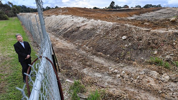 Curt Thompson stands at the boundary of a former quarry and rubbish dump in Oakleigh south.