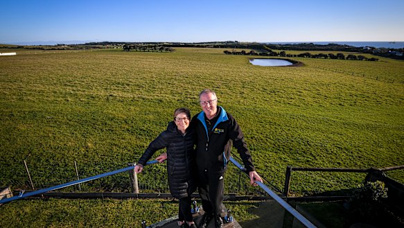 Land owners Karen Green and Robert Newall and, in the background, the farmland Matthew Guy briefly rezoned for housing.