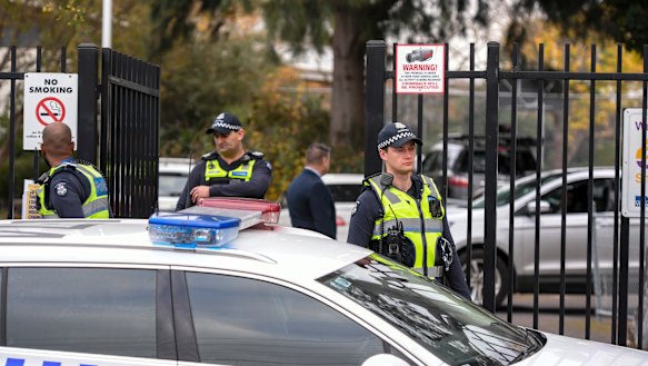 Police at the entrance of Victoria University Secondary College on Wednesday morning.