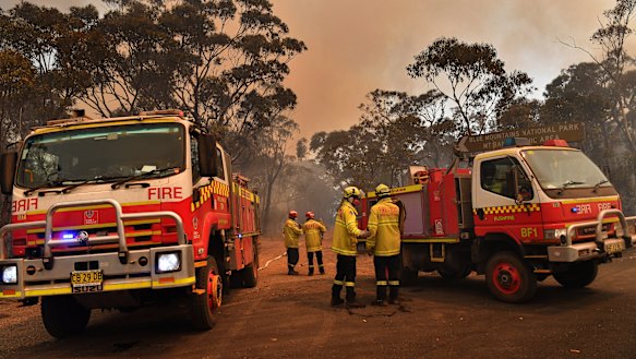 NSW Rural Fire Service and Fire and Rescue crews work on the Gospers Mountain fire on Tuesday.
