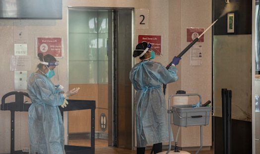 Cleaners wearing full PPE at the Holiday Inn in Melbourne last week.