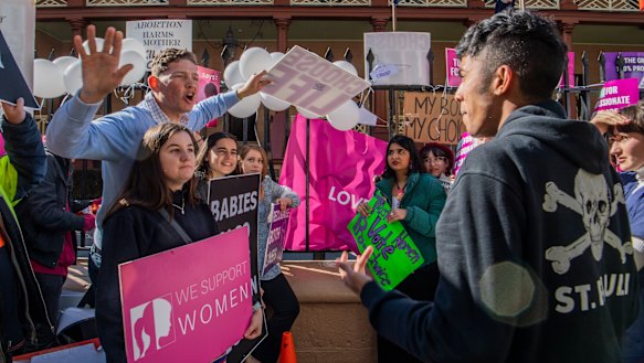 Anti-abortion and pro-choice campaigners protest outside NSW Parliament in July.