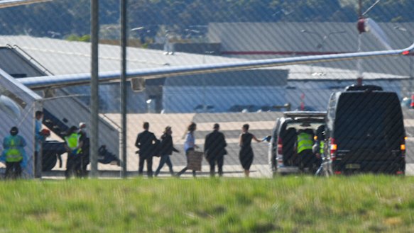 Passengers, including one believed to be British-Australian academic Dr Kylie Moore-Gilbert, leave a government jet at Canberra Airport.