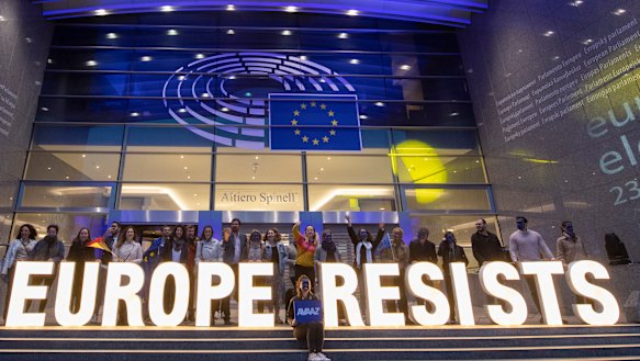 European citizens celebrate with illuminated letters on the steps of the European Parliaments as election results come in.