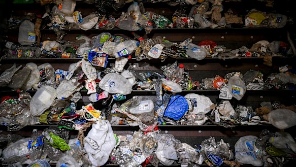 The items are fed into machines with rollers and conveyor belts to help sort and separate the different types of plastic.