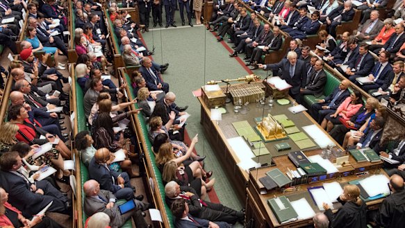 Britain's Prime Minister Boris Johnson, centre right, gestures during his first Prime Minister's Questions.