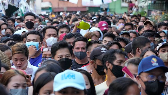 People wait in line to vote at a school used as a polling station in Tondo district of Manila.