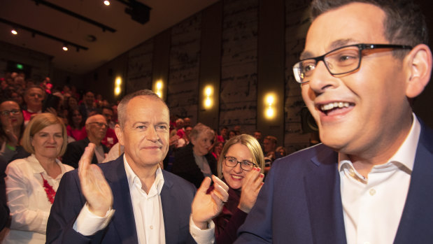 Federal Opposition Leader Bill Shorten (left) applauds as Victorian Premier Dan Andrews arrives to the Victorian Labor Party's official state election campaign launch event at Monash University