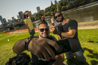 'Melbourne has better nightlife': Trent Auld, of western Sydney, taking a selfie, and a group of friends and relatives started their New Year's Eve early on the Yarra bank near Princes Bridge. 
