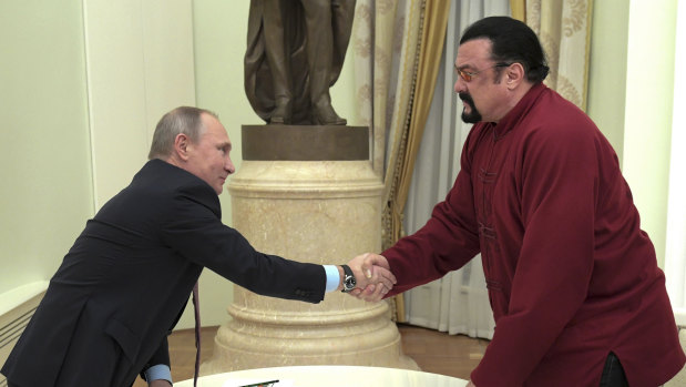 Russian President Vladimir Putin shakes hands with US actor Steven Seagal in the Kremlin in Moscow on November 25, 2016.