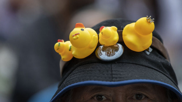 An anti-government protester wears a hat decorated with yellow ducks in Bangkok, Thailand, in 2020.