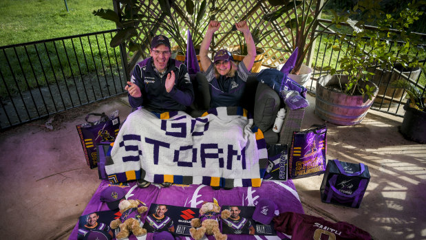 Melbourne Storm fan Bronwyn Smith with her son-in-law Warren Hall prepare to watch the team from home on Saturday night.