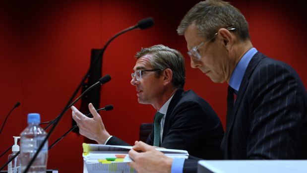 NSW Premier Dominic Perrottet (left) and Michael Coutts-Trotter (right) during budget estimates last week.