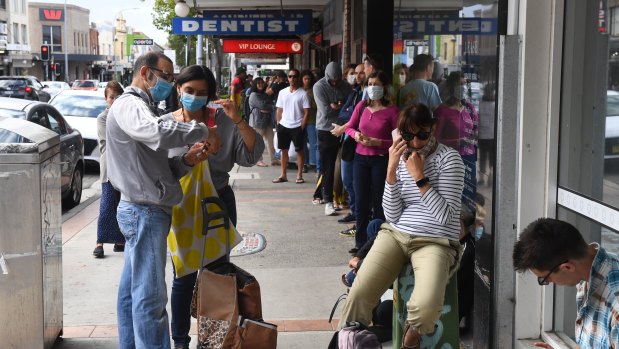 People queue at Centrelink in Sydney. 