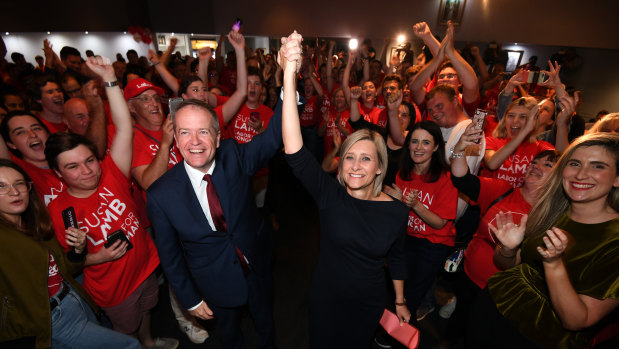 Labor leader Bill Shorten and returned MP Susan Lamb celebrate as they arrive at their election night function in Caboolture, north of Brisbane, on Saturday.