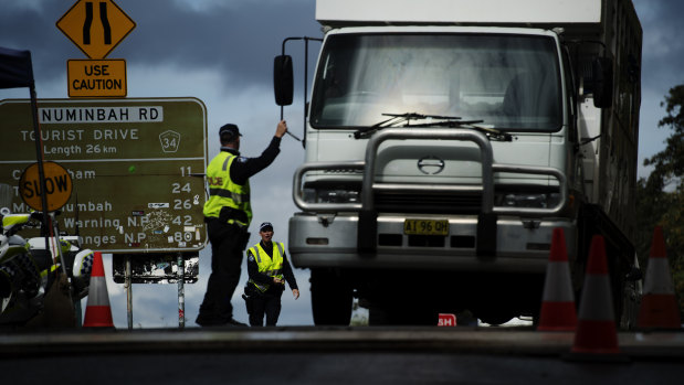 Commuters are stopped by police at the Queensland - NSW border checkpoint in the Gold Coast hinterland at Nerang Murwillumbah Road, near Natural bridge