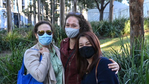 Gail Rodney, Dayna Kohn and Tomoko Masters arrive for the opening of the Olympic Park vaccination hub on Monday at 8am.