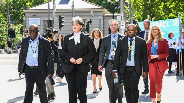 Uncle Paul Kabai (left) and Uncle Pabai Pabai (second from right) walk into the Federal Court in Melbourne. 