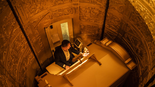 Organist John Giacchi playing the Wurlitzer organ as it ascends in its console from the stage. 