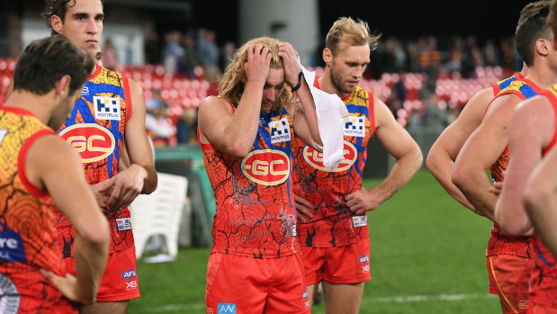 Suns players after their loss to Adelaide at Metricon Stadium in round 17.