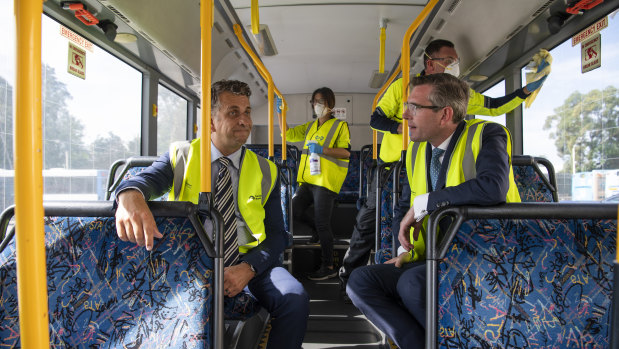 Transport Minister Andrew Constance and Treasurer Dominic Perrottet on board a bus.
