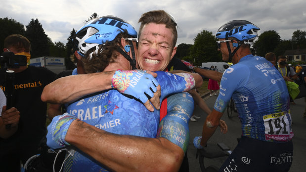 Stage winner Simon Clarke is congratulated by a teammate.