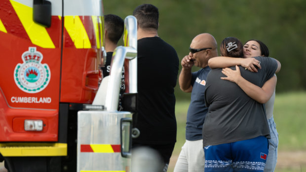 Family members gather at Penrith Beach while emergency services search for a missing man.