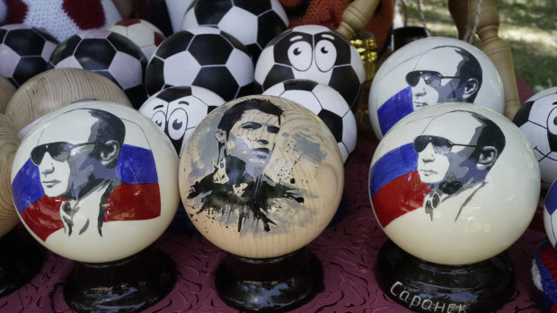 Hand made wooden balls depicting Russian President Vladimir Putin and soccer star Cristiano Ronaldo are for sale as souvenirs in Saransk, Russia.