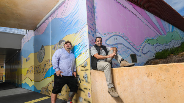 Indigenous artists Eamon Roberts, a Kamilaroi man (left) and Adam Magennis, a Bunurong man (right) painted murals at the Eel Race Road underpass, as part of a push to incorporate more Indigenous culture and art into the level crossing removal program. 