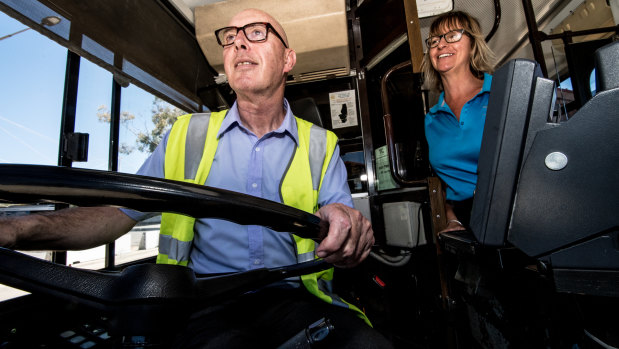 Whoops! Steve Evans takes the wheel of a Canberra bus guided by driver, Karan Kenny.