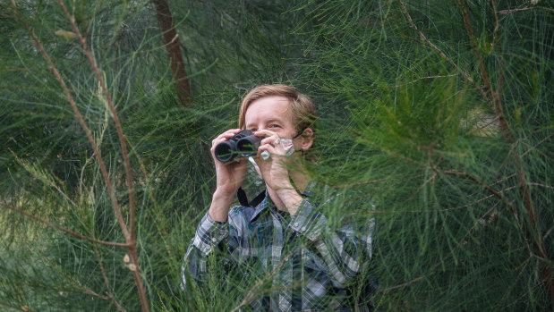 Michael Livingston searches for birds in Royal Park during lockdown. 