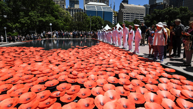 Poppies floating in the new cascade at the Anzac Memorial on the centenary of the armistice.