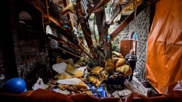 John Carlyle in his Kalorama home, which was partly destroyed by five falling trees.