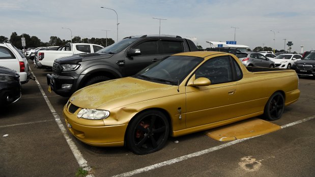 A Holden ute without number plates in a long-term car park.