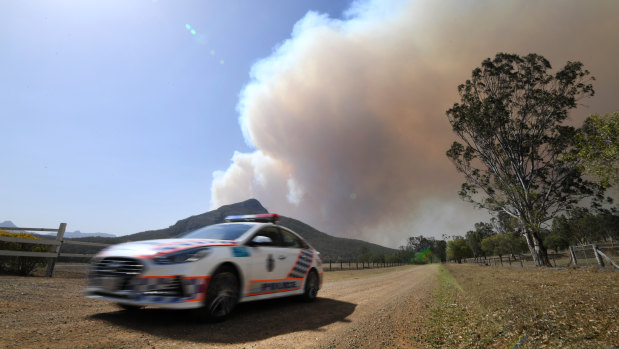 Smoke from an out-of-control bushfire billows near Clumber, south of Boonah in the Scenic Rim region, on Friday. 