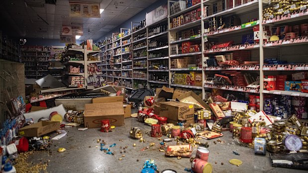 A store is seen vandalized by protesters who believe it to be associated with organized crime groups during a protest against a government ban on face masks in Yau Ma Tei.