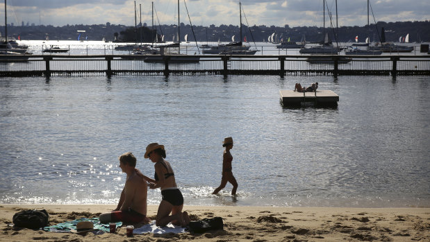 Bathers enjoy warm late autumn weather at Red Leaf Beach in Double Bay, Sydney.