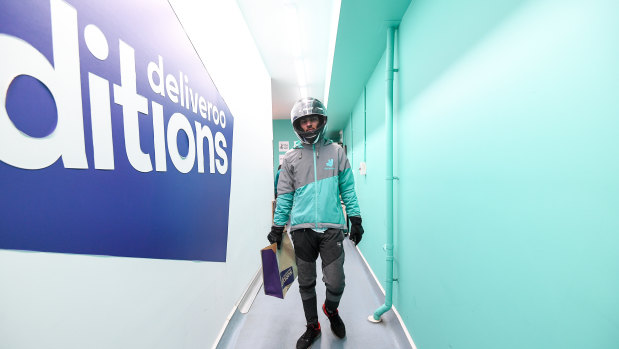 A delivery rider takes an order from Deliveroo's dark kitchen in Windsor. 