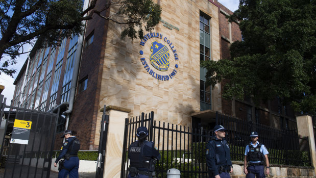 Police outside Waverley College, where a student has been diagnosed with COVID-19.