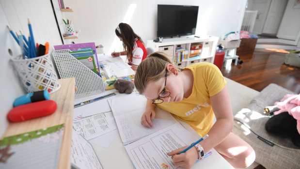 Grace Merriman (front), 8, and her sister Audrey, 9, are seen learning from home on the first day of term 2 in Brisbane.