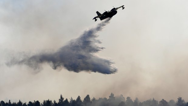 Water is dropped on a wildfire near Halkida town on Evia on Wednesday.