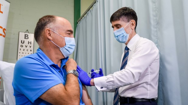 CSL’s chief scientific officer Dr Andrew Nash is vaccinated with the locally manufactured AstraZeneca vaccine by Dr Tony Bartone, the immediate past president of the Victorian AMA. 