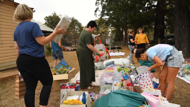 Community members sort out donated Christmas presents into categories in Balmoral, which was severely impacted by fires.