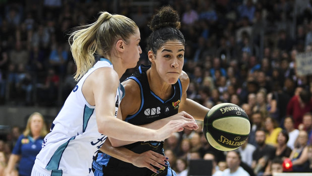 Canberra Capitals' Kia Nurse fights for the ball with Aimie Clydesdale of the Southside Flyers.