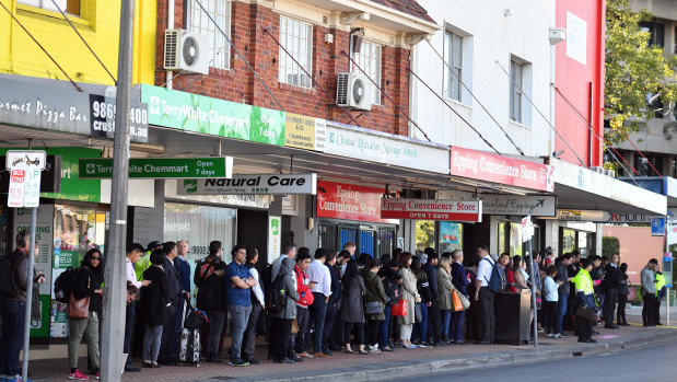 Commuters queue for replacement buses near Epping train station on Tuesday morning.