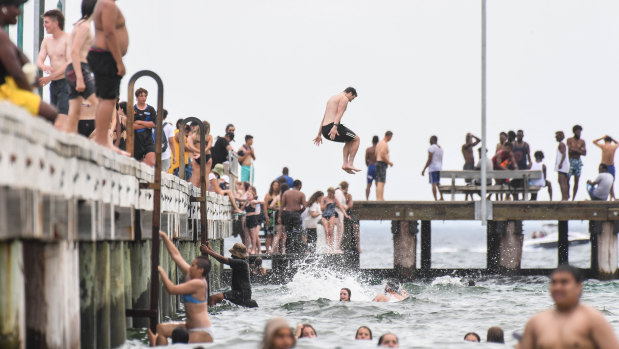 Thrill seekers take a plunge off Frankston pier on Monday.