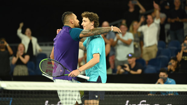 Nick Kyrgios and Ugo Humbert share a hug over the net after a marathon match.